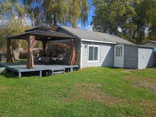 a house with a gazebo in a yard at Cozy Cabin Getaway Close to Town in Gladwin