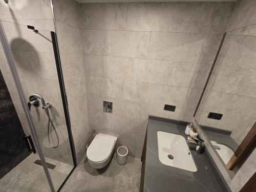a bathroom with a shower and a toilet and a sink at 'Ultra Luxury Holiday Apt in the Heart of the City in Alanya