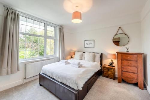 a bedroom with a large bed and a window at 4 Bed in Woolacombe oc-h33441 in Mortehoe