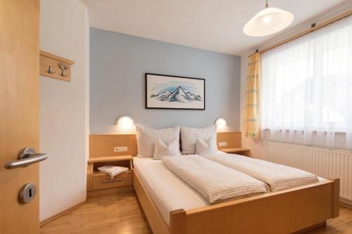 a bedroom with a bed and a window at Siegele Irmgard in Kappl