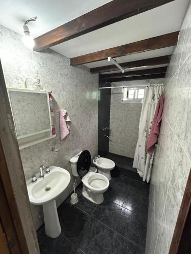 a bathroom with two toilets and a sink at El EDEN in Mar de Cobo