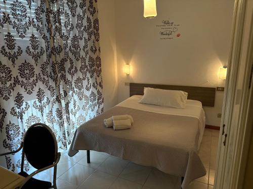 um quarto com uma cama com duas toalhas em Hotel Azzurra em Montecatini Terme