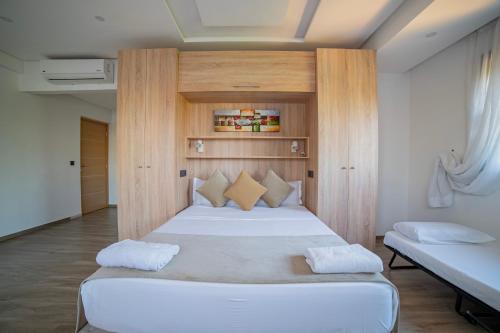a bedroom with a large white bed in a room at Villa Arabic House Pool & SPA, Marrakech in Marrakech