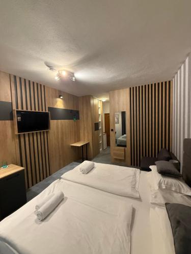 a hotel room with a bed with two white towels on it at White Stone Villa 43 in Promajna