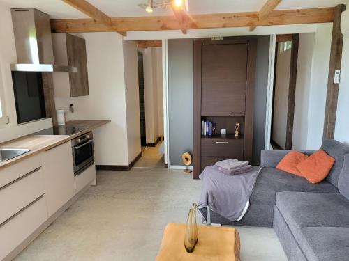 a living room with a couch and a kitchen at Prins van Poederoijen in Poederoijen