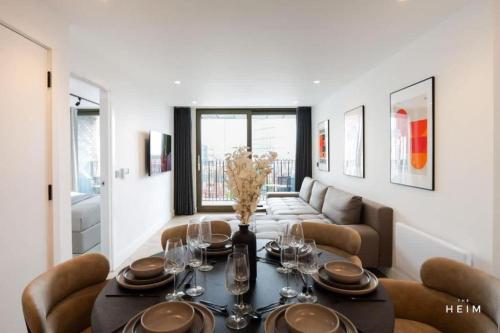 a dining room with a table and a couch at Urbano at The Heim in Manchester