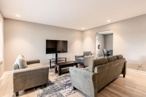 a living room with two couches and a flat screen tv at 3 Bedroom home near DC in Oxon Hill