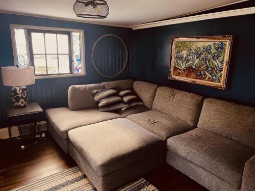a living room with a couch and a mirror at Historic Home in Harpers Ferry National Park in Harpers Ferry