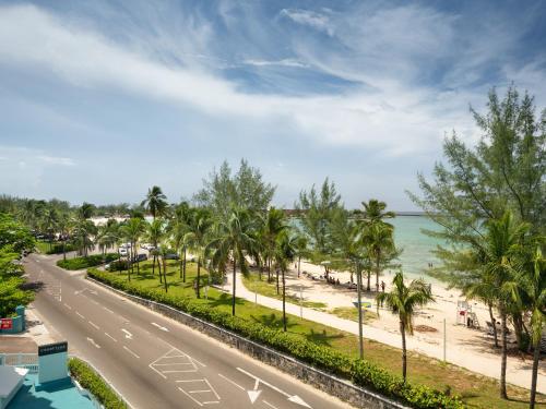 拿骚拿骚市区/贾卡努海滩万怡酒店的一条棕榈树和海滩的街道