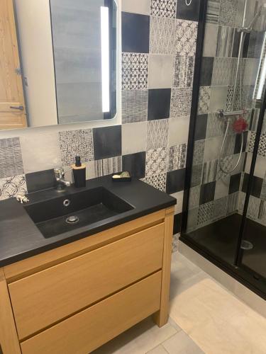 a bathroom with a sink and a shower at cocon beaujolais in Anse