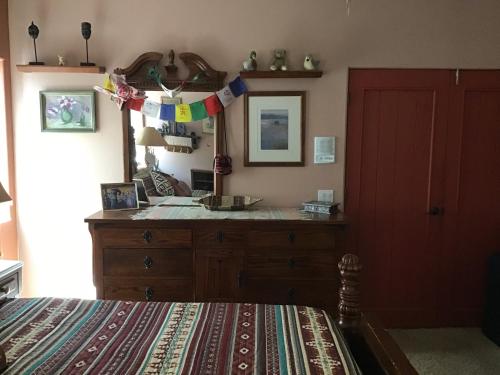 a bedroom with a dresser and a mirror at Mystic Canyon Inn in El Cajon