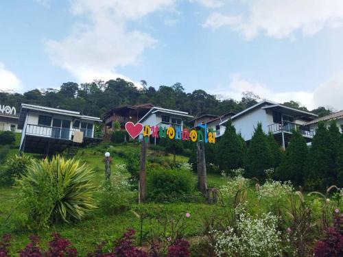 a yard with flags and houses in the background at Phumokdokmai Resort in Ban Seng Choi