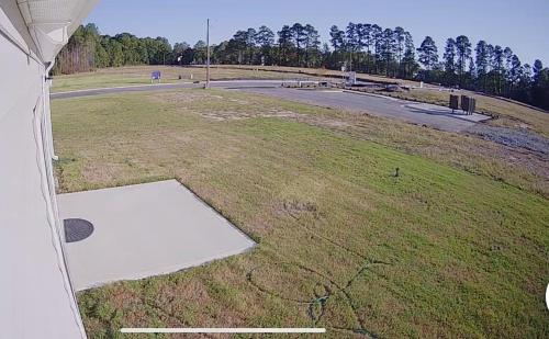 an empty field with a road in the distance at Wilson Retreat in Wilson