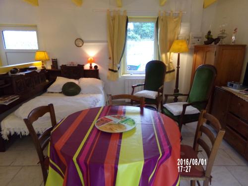 a room with a table and a bed and a bed at Ty Kozh De L'aber in Crozon