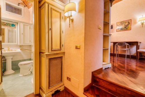 a bathroom with a fireplace and a sink in a room at Affreschi and Vintage Charm in Bergamo