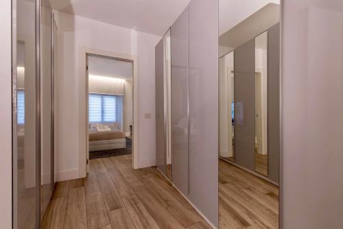 a hallway with mirrors and a bed in a room at Charming & Luxurious Suite Garibaldi BIG - Fully equipped & renovated - Old Town in Olbia