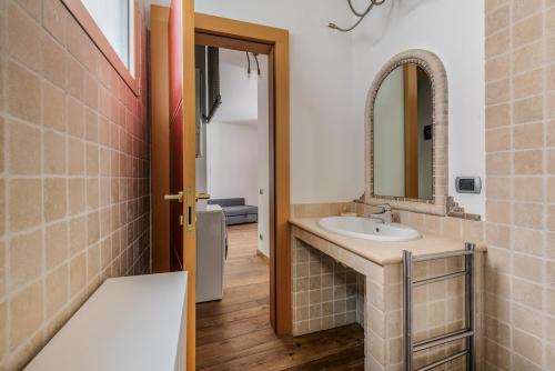 a bathroom with a sink and a mirror at Città alta Apartment-comfort in Bergamo