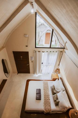 a small bedroom with a bed in an attic at Luna and Sol Beach Resort in Zambales