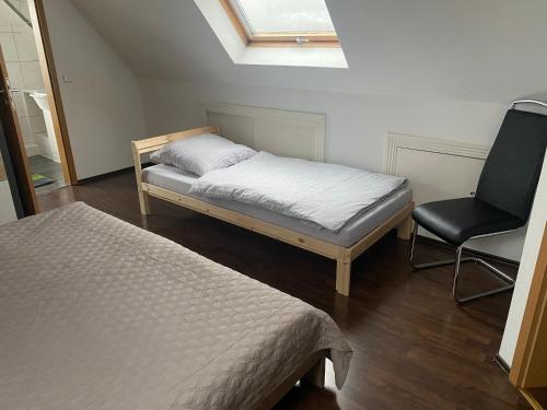 a small bedroom with a bed and a chair at Maisonette - apartment in Siegen in Siegen