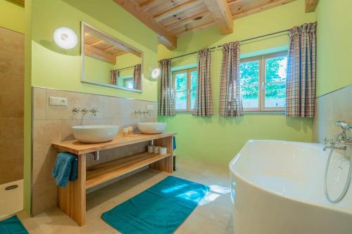 ein Badezimmer mit zwei Waschbecken und einer Badewanne in der Unterkunft Englburger Hof in Fürstenstein