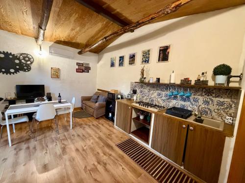 a kitchen and living room with a table and a dining room at Casetta sull’Etna in Nicolosi