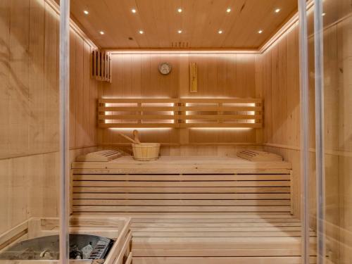 a sauna with a tub with a clock in it at Chalet rénové 10 personnes à Tignes, sauna inclus - FR-1-641-121 in Tignes