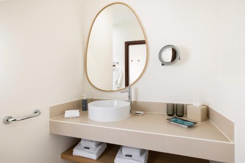 a bathroom with a sink and a mirror at The Westin Salgados Beach Resort, Algarve in Albufeira