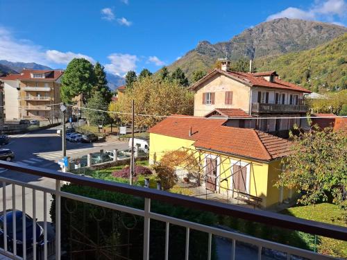 a balcony with a view of a street and mountains at Casa Camelia in Torre Pellice