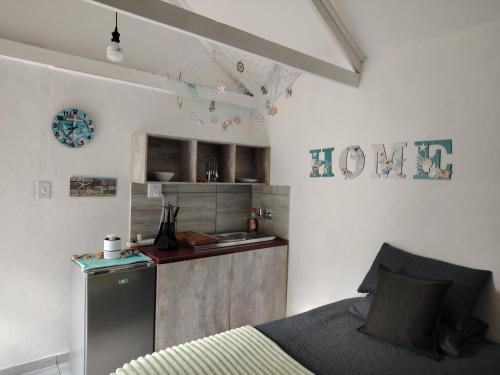 a bedroom with a bed and a kitchen in it at Aloe Haven in Lichtenburg