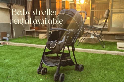 a baby stroller rental available sitting on the grass at Jikka Japan in Izumi-Sano