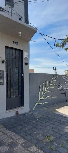 a building with a wall with a painting on it at Espaço Harmonia - um apartamento inteiro e aconchegante para vc! in Curitiba