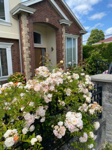 a bunch of flowers in front of a house at independent entrance cozy room with private bathroom close to YVR Richmond in Richmond