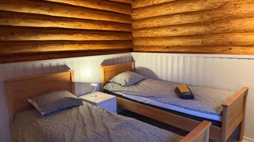 Postel nebo postele na pokoji v ubytování Hännänpää - TailTip