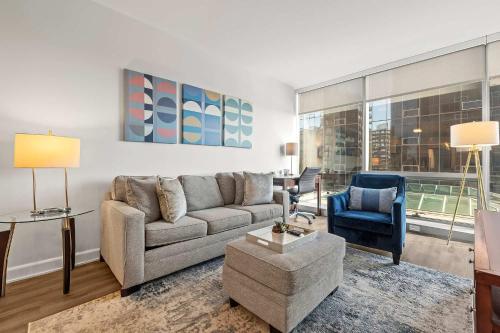 a living room with a couch and a chair at Luxury Modern Apartment Near Stamford Station in Stamford