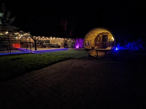 a night view of a round house with lights at A historic Pub with a modern twist - The Greyhound in Bury Saint Edmunds