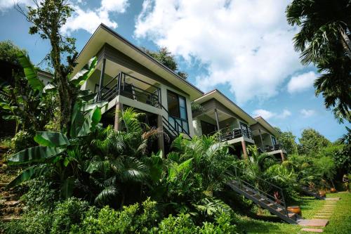 a house with a lot of plants in front of it at KAI BAE BALCONY Hills Bungalows Koh Chang in Khlaung Phai Bae