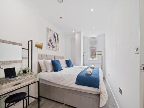 a bedroom with a bed and a desk with a computer at The Sapphire Suite - 2BR 2Bath City Centre in Leicester