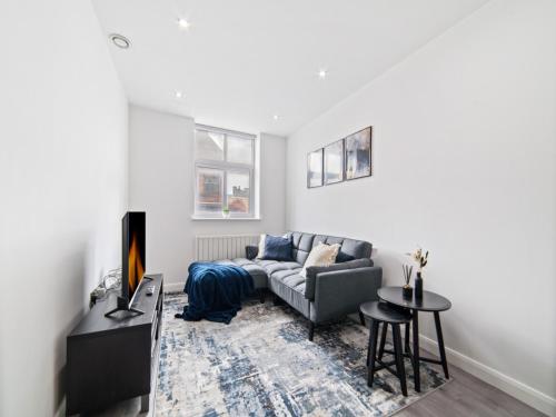 a living room with a couch and a table at The Sapphire Suite - 2BR 2Bath City Centre in Leicester