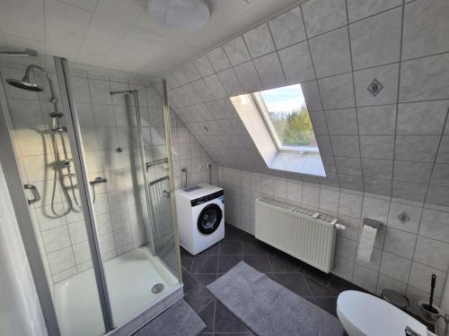 a bathroom with a shower and a toilet and a sink at Ferienwohnung Fehnzeit in Rhauderfehn