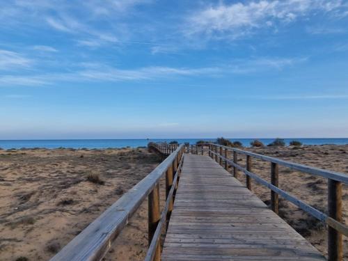 a wooden boardwalk leading to the beach at Iconic Zuza in Gran Alacant