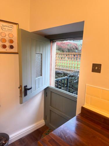 a small window in a room with a door at La Casa De Campo in Long Preston