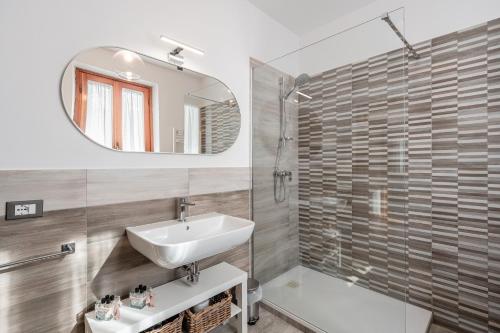a bathroom with a sink and a mirror at Casa Marcobando - Lucca in Lucca