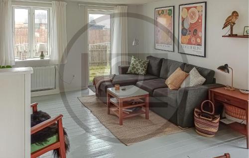 a living room with a couch and a table at Lovely Home In Thyborøn With Wifi in Thyborøn