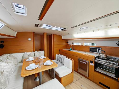 a room with a table and a kitchen on a boat at Unique Yacht Stay Near Historic Valletta in Tal-Pietà