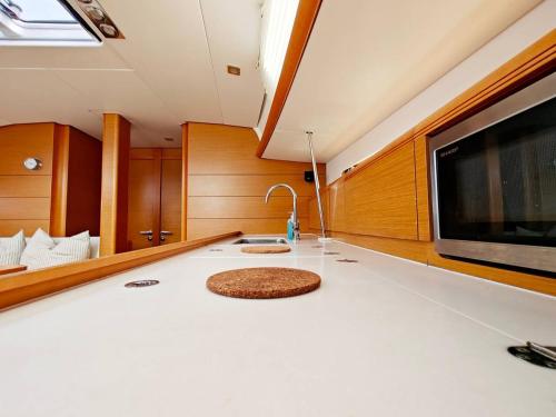 a living room with a sink and a tv at Unique Yacht Stay Near Historic Valletta in Tal-Pietà