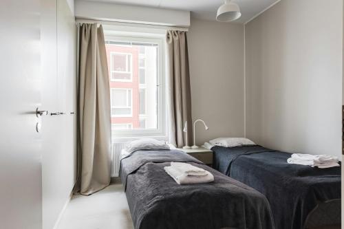 a room with two beds and a window at Spacious Apartment for 5 with Sauna in Masala