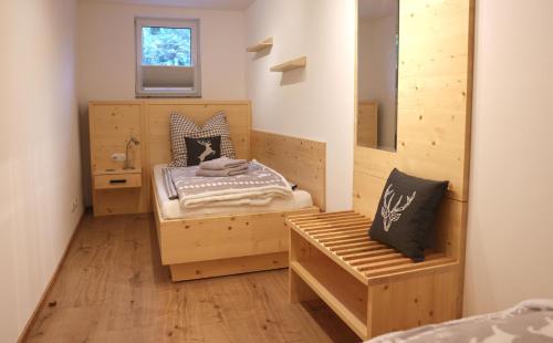 a bedroom with a bed and a bench in it at Berghaus zum Hirsch in Gehlberg