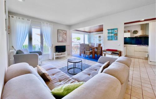 a living room with a couch and a table at Charmant Appartement Vue Mer in Saint-Georges-de-Didonne