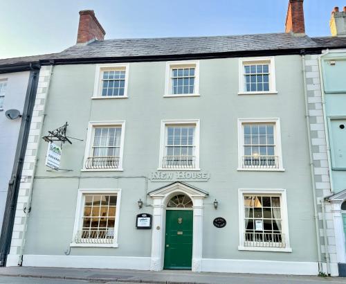 a white house with a green door at The Beacons Guest House in Brecon
