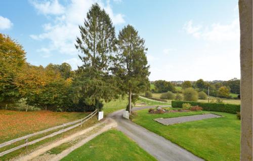 a winding road in a park with a tree at Charmante Maison Au Calme in Saint-Clément